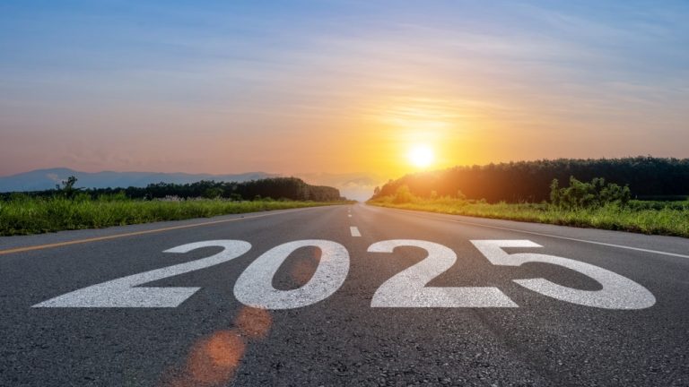 2025 written on a road with a sunset