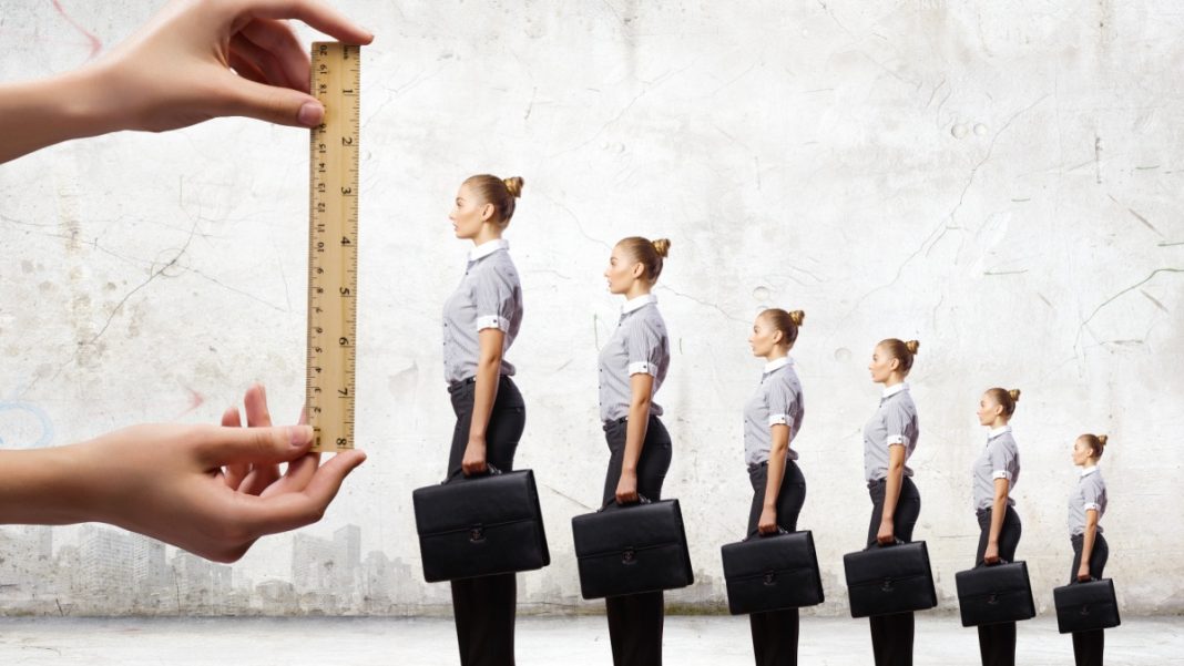 Several businesswoman, each successive one if slightly taller, signifying career progression