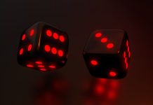 Aplicativo da Aposta Ganha conta com super odds aumentadas e exclusivas Imagem de dados pretos com vermelho neon