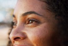 Esportes da Sorte reduz tempo de atendimento para menos de 2 minutos “sem perder olhar humano” Rosto de mulher de lado, sorrindo, com foco nos olhos