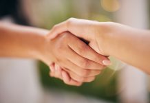 Omnitronix taps BetComply to support slot expansion Close up of a handshake