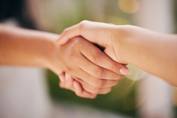 Hub88 x Black Lagoon Close up of a handshake