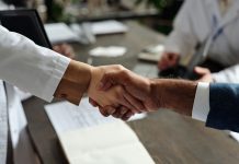 SKillOnNet strikes Swintt content deal Close up of a handshake