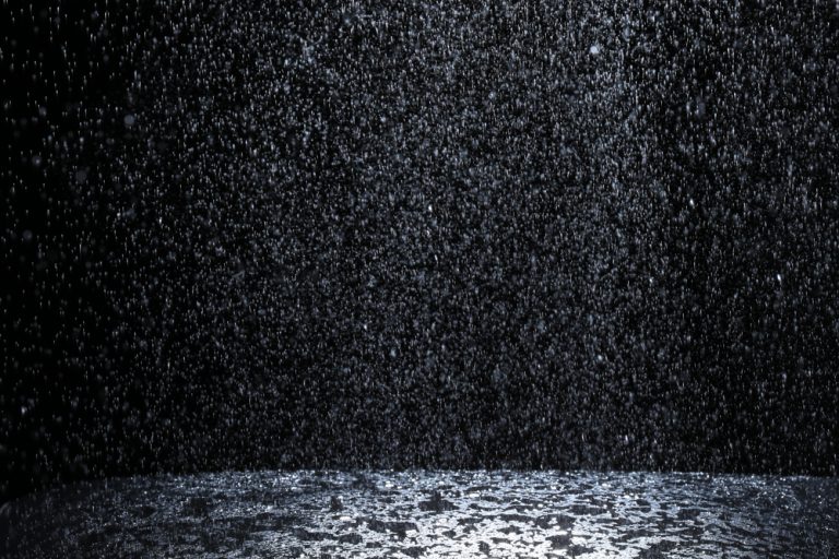 Rain falling in front of a dark sky
