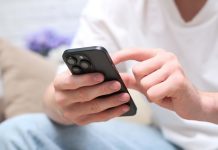 155.io strikes Elantil content partnership for mobile-focused games Man holding phone