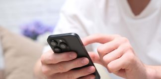 155.io strikes Elantil content partnership for mobile-focused games Man holding phone