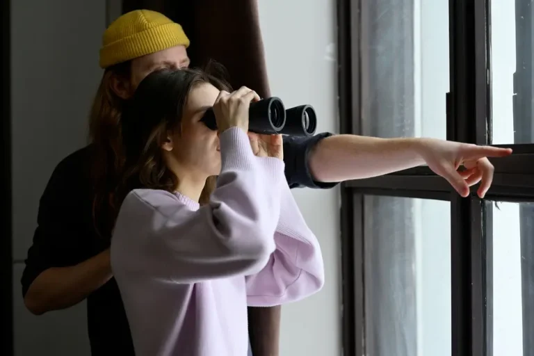 Person looking through binoculars