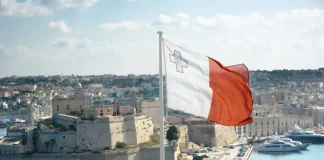MGA publishes new charter as AI use intensifies Malta flag with bay in background