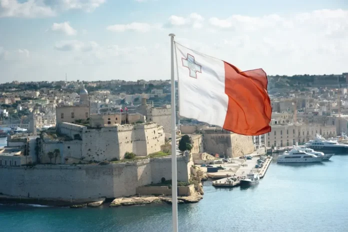 Malta URLS Malta flag with bay in background
