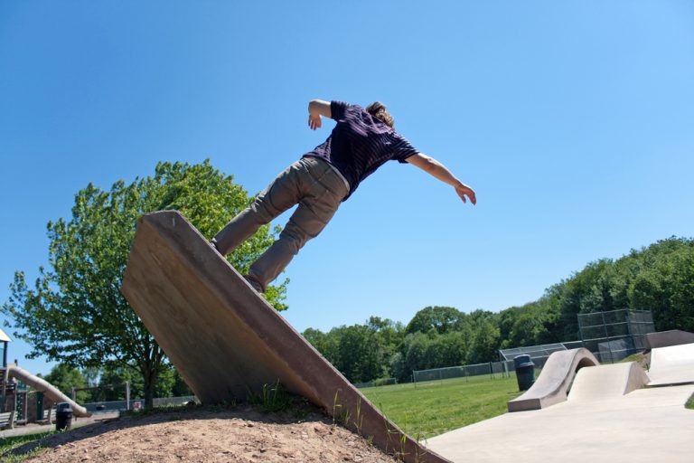 Skateboarder up ramp